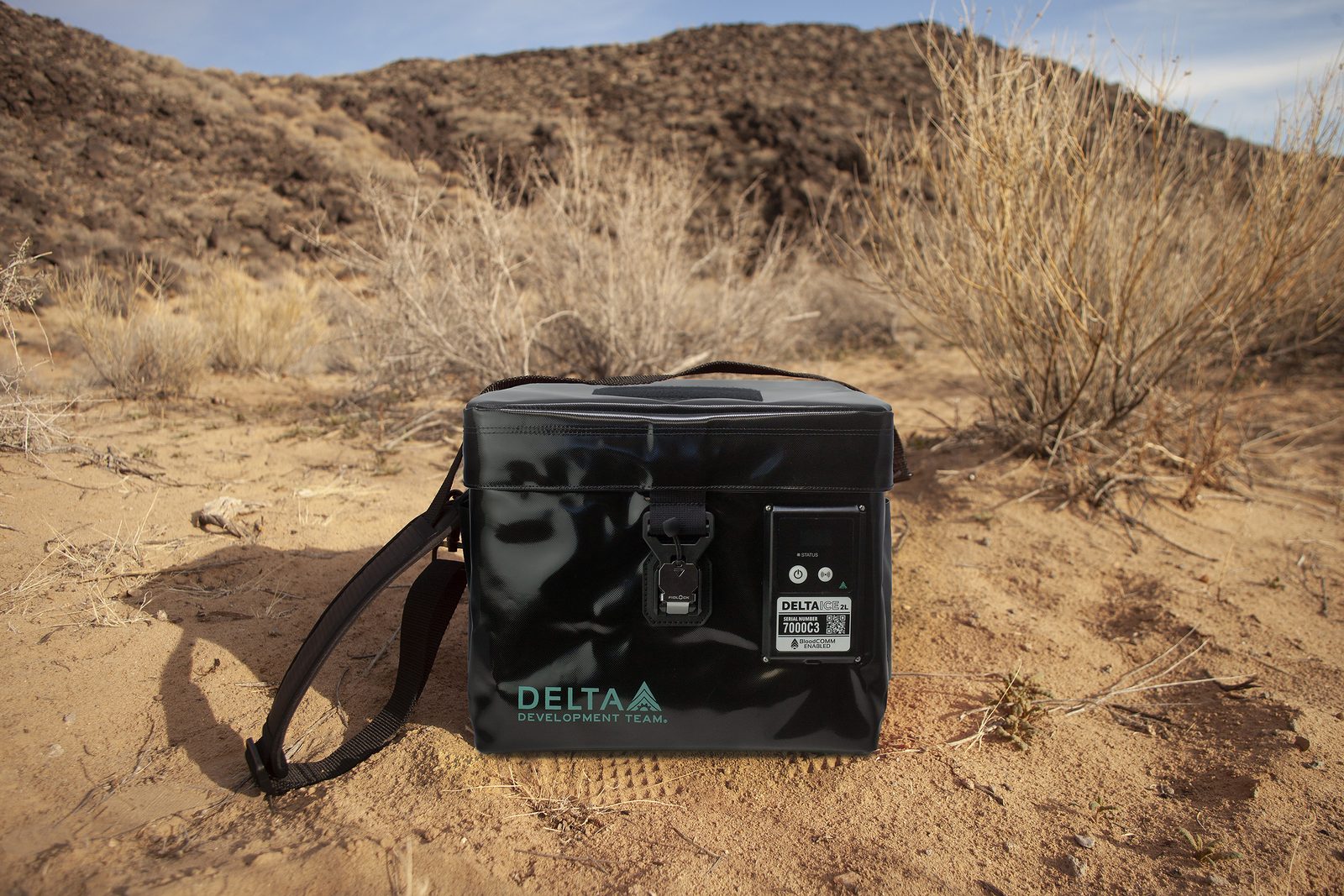 Delta Development Team’s smart blood cooler, an insulated case for carrying blood by drone, set on desert ground